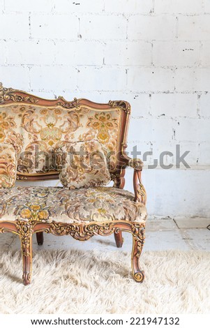 Brown armchair sofa on white wall.