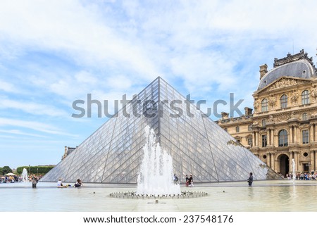 PARIS, FRANCE - JULY 24: The Louvre Pyramid at dusk during the Michelangelo Pistoletto Exhibition on July 24, 2014 in Paris. The Pyramid is the main entrance to the Louvre Museum.