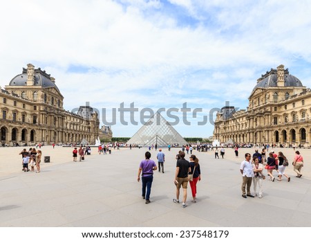 PARIS, FRANCE - JULY 24: The Louvre Pyramid at dusk during the Michelangelo Pistoletto Exhibition on July 24, 2014 in Paris. The Pyramid is the main entrance to the Louvre Museum.