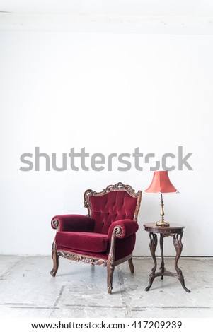 Red vintage sofa and lamp on white wall.