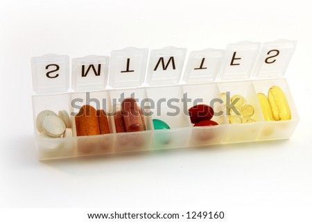 Pill box filled with variety of pills and supplement.