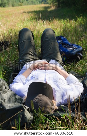 Female tourist taking nap in a field