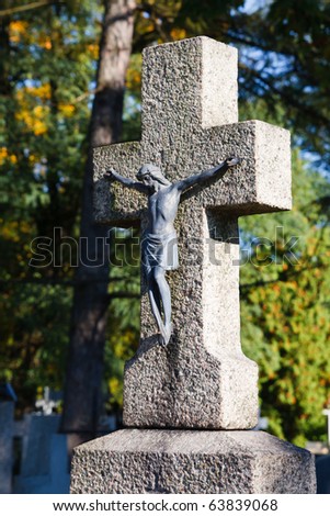 Stone cross with metal figurine of jesus christ