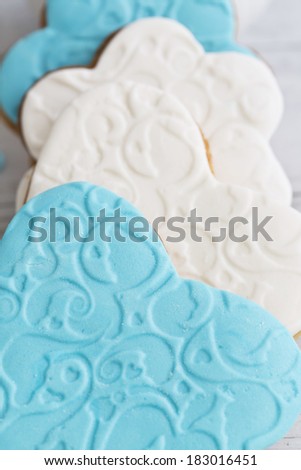 Shortbread cookies in the shape of heart decorated with sugar paste