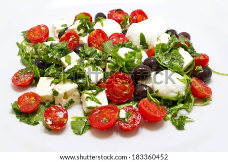 Salad with rucola, feta cheese, black olives and mozzarella cheese