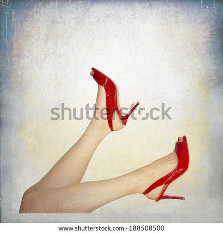 Perfect female legs wearing high heels isolated on white background