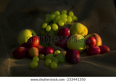 Light painting of mixed fruit on a rustic cloth