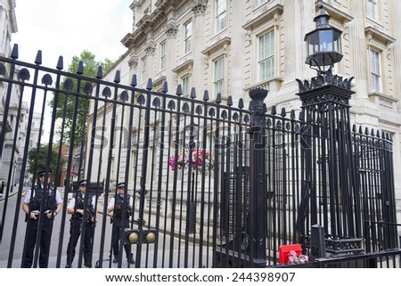 LONDON, UK, July 28, 2010: A police officer guards the door of 10 Downing Street in London.