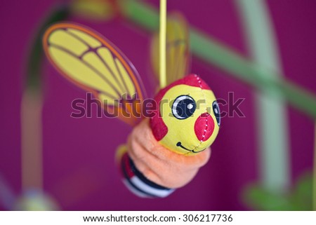 Little bee hanging above baby bed. Joust. Toys for babies