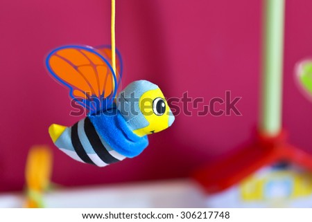 Little bee hanging above baby bed. Joust. Toys for babies