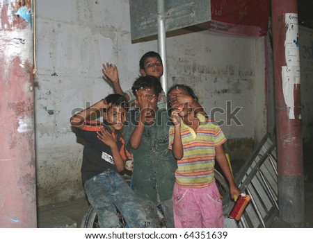 KARACHI, PAKISTAN - SEPT. 8: Poverty-stricken, street kids pose for the camera at a commercial street in Karachi, Pakistan on September 8, 2010