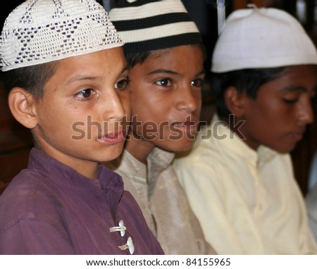 KARACHI, PAKISTAN - JULY 10: Unidentified Muslim boys read the holy Qur'an in Karachi, Pakistan on July 10, 2010. The majority of the country's population practice Islam.