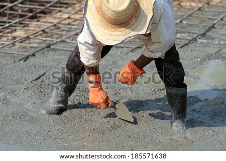 labor working on concrete at construction site