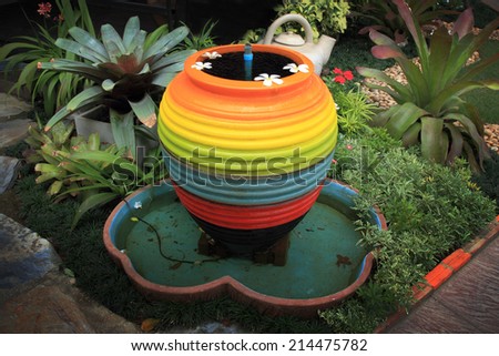 rainbow water jar and fountain in the garden