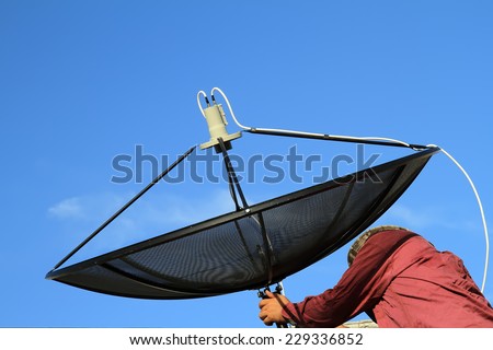 a man installing the satellite dish