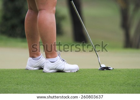 Golfer putting golf
