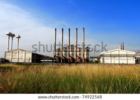 Factory and green meadow