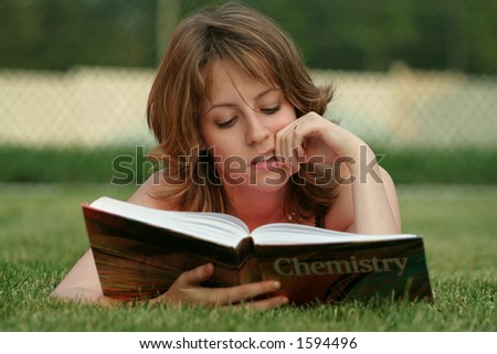 Beautiful girl reading a science book outdoor