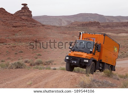 MEXICAN HAT, UTAH, USA - April 25: Custom Expedition Vehicle RV driving on dirt road in the Valley of Gods, Utah on April 25, 2014.