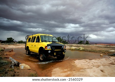 Yellow 4x4 van off road during storm in Utah