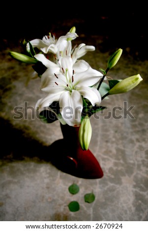 White lily bouquet in Chinese terracotta vase