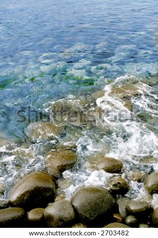 Blurred waves rolling onto rocks