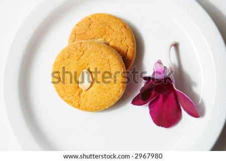 Almond cookies on plate with orchid
