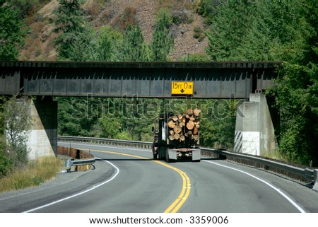 Logging truck driving on winding road