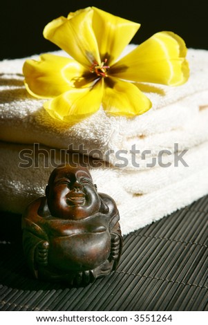Buddha, flower and towel arrangement