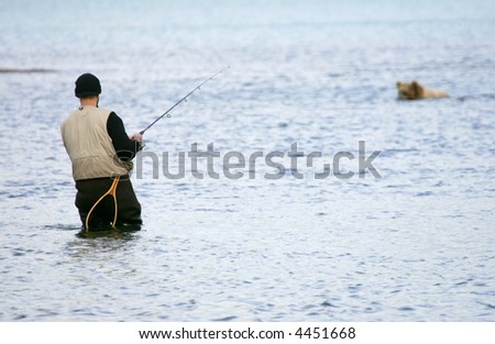Fisherman and bear fishing for salmon, Katmai National Park, Alaska