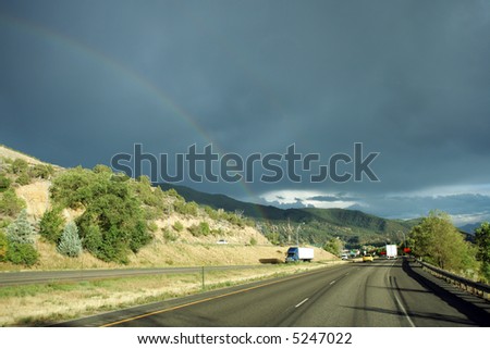 Rainbow after storm above interstate highway, Colorado
