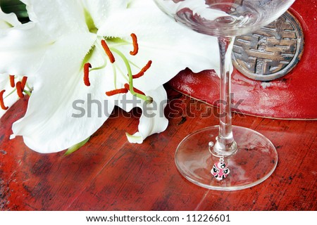 Chinese pottery vase, white lily and wine glass, China