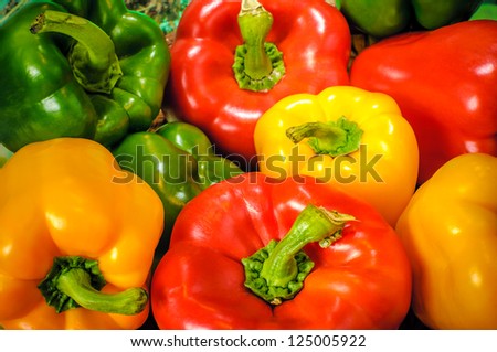 Yellow, green and red colorful bell peppers, natural background