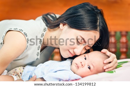 Beautiful mom holding her cute baby.