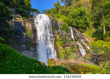 Water fall in spring season located in deep rain forest jungle.