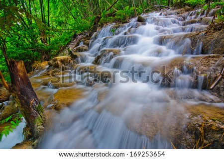 Waterfall in spring season located in deep rain forest jungle