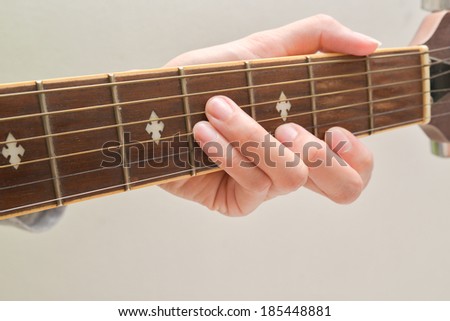The hand of the musician shows the guitar cord.