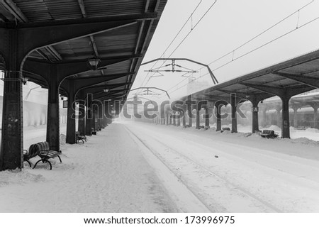 Black and white winter storm in train station in Romania