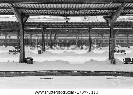 Black and white winter storm in train station in Romania