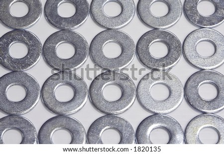 An arrangement of zinc plated flat washers in rows