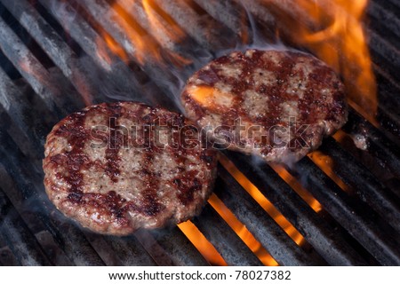 Hamburgers on Grill with Dancing Flames Cooked to Perfection