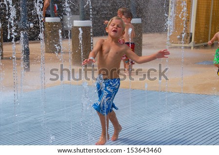 Walking through the spray park on a hot summer day