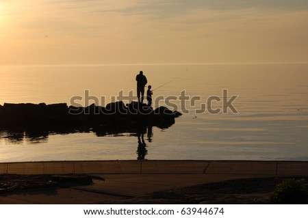 Father and son fish off pier on a summer evening/Evening Fishing/ Finding time together