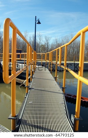 Footbridge stretches across the water to the safety of the light on the other side/Footbridge to the Light/Take precautions to get to Safety