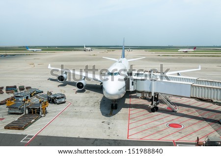 A jumbo jet is parked at the boarding gate.