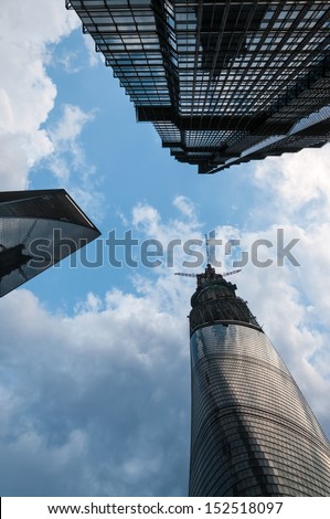 SHANGHAI, CHINA - AUGUST 1: Looking up at the Jin Mao Tower, the Shanghai World Financial Center, and the currently under construction Shanghai Tower on August 1, 2013 in Shanghai, China.