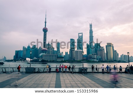 SHANGHAI, CHINA - AUGUST 3: Photographers are out early to take photos of the Shanghai skyline on August 3, 2013 in Shanghai, China.