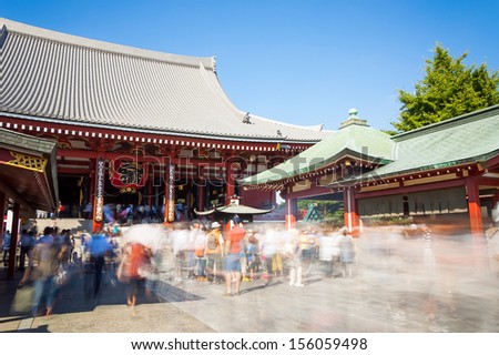 Tourists and sightseers move around in a blur at Sensoji Temple in Tokyo, Japan.