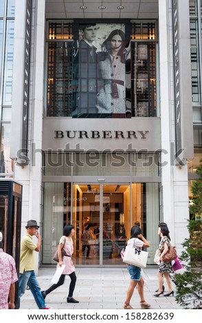TOKYO, JAPAN - SEPTEMBER 22: Shoppers and tourists pass by a Burberry store in Ginza on September 22, 2013 in Tokyo, Japan.