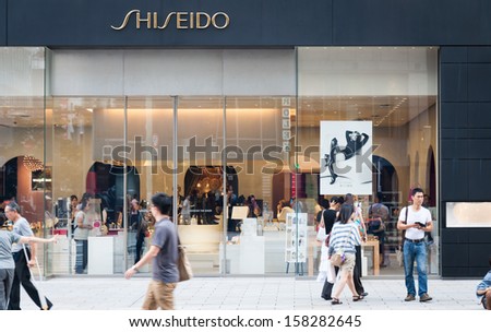 TOKYO, JAPAN - SEPTEMBER 22: Shoppers and tourists pass by a Shiseido shop in Ginza on September 22, 2013 in Tokyo, Japan.